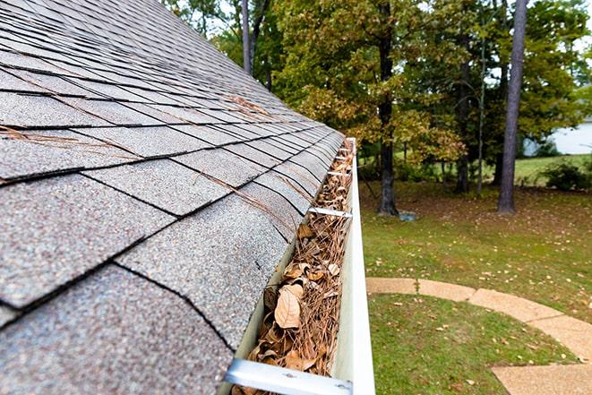 clearing out leaves and debris from gutters